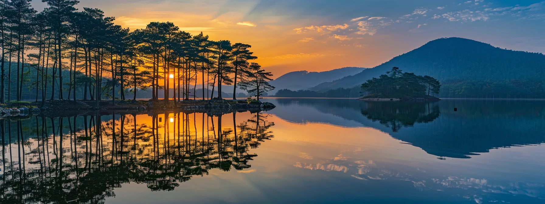 a vibrant sunset casts a golden hue over a tranquil mountain lake, reflecting the silhouette of towering pine trees against the clear, glassy water.
