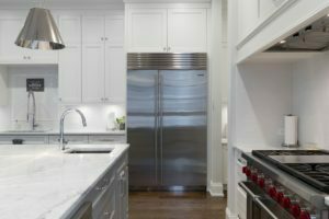 a kitchen with a refrigerator and sink