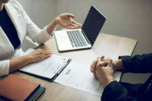 Female managers are talking about the recruitment of staff at the office.